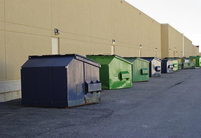 a fleet of red and blue construction dumpsters available for use in Berkeley, IL